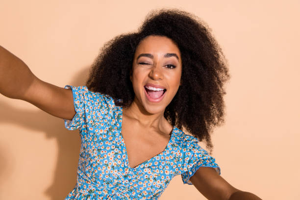 istock Photo of shiny attractive lady dressed blue blouse tacking selfie winking eye empty space isolated beige color background 2159349541
