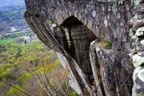 istock solid rock cliff face with cobble stone bridge in black and white, high on Lookout Mountain in Chattanooga Tennessee with view of city below. 2159349701