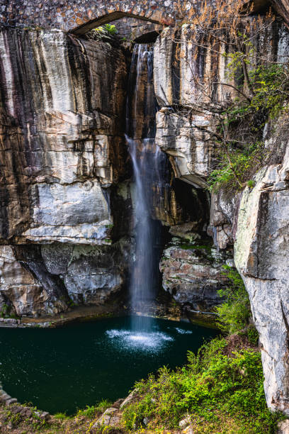 istock Beautiful view of high waterfall surrounded by rock cliffs falling into pool of water below on Lookout Mountain in Chattanooga, Tennessee 2159349848