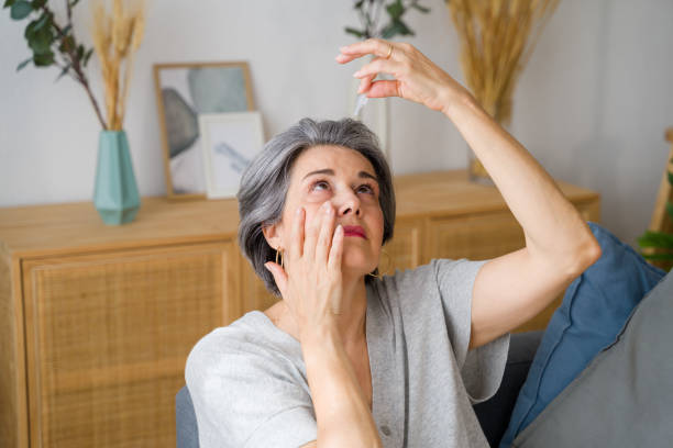 istock Senior woman applying eye drops suffering from cataract 2159350778