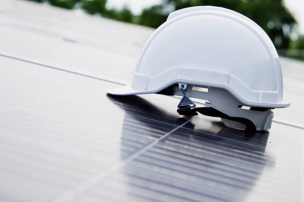 istock White safety helmet on solar panels close-up Solar panel installation ideas Hard hat on solar panel. 2159351041