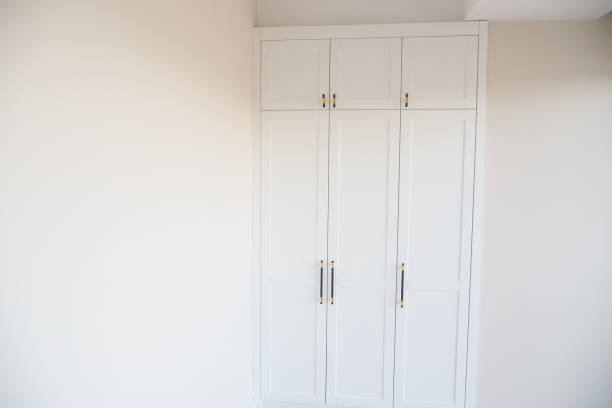 istock Minimalist white wardrobe complements room, emphasizing simplicity in contemporary design 2159351487