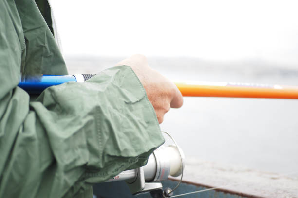 Fisherman with rod, spinning reel