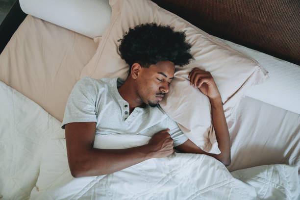 istock A young man sleeping on the bed in the bedroom 2159352726