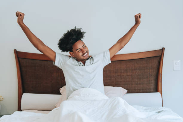 istock A young man waking up in his bedroom bed 2159352780