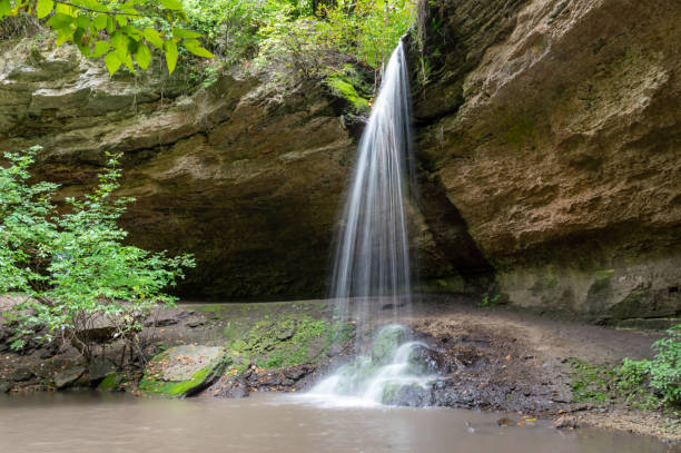 istock Small waterfall in natural landscape with rocks and trees 2159353643
