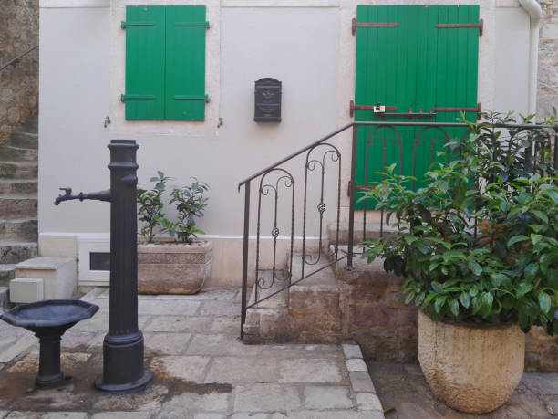 Detached house with cute green windows. stairs in front