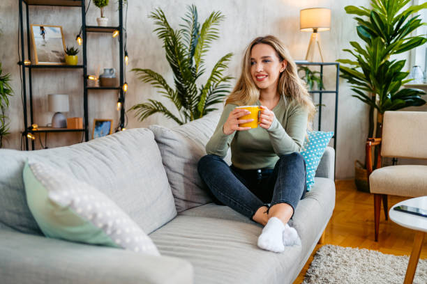 istock Young Woman Drinking Coffee On The Sofa At Home 2159356682