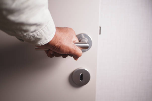 istock Man's Hand Opening door close up 2159356891