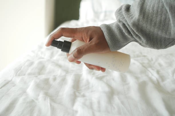 man use spray for clean the bed at home