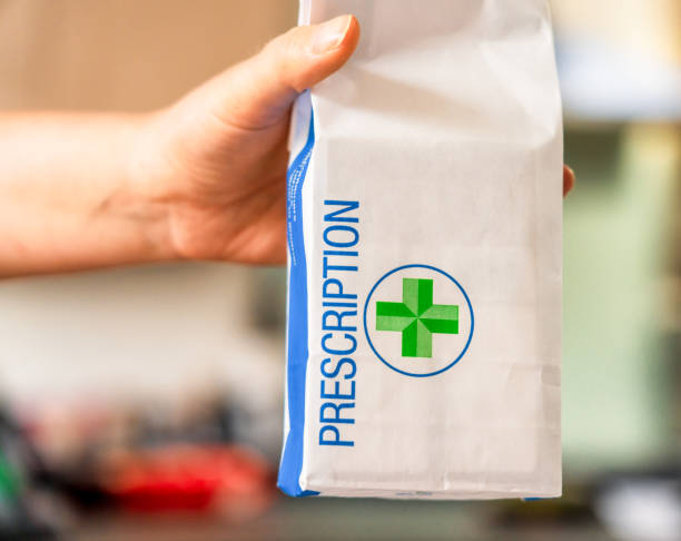 istock Pharmacist holding out prescription 2159357505