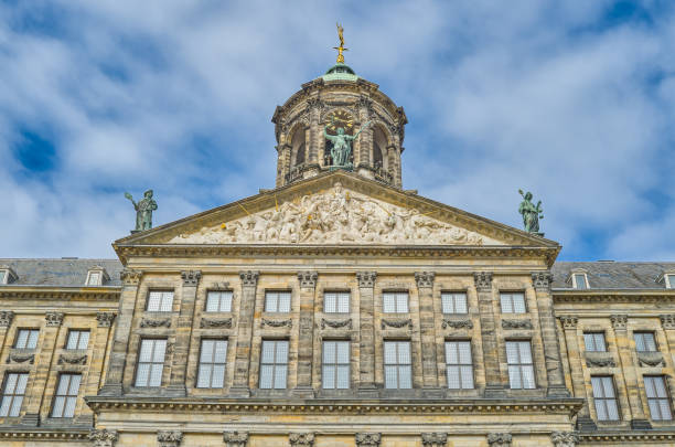 Amsterdam,Holland - August 10, 2023: The  upward view of the main facade of the Royal Palace