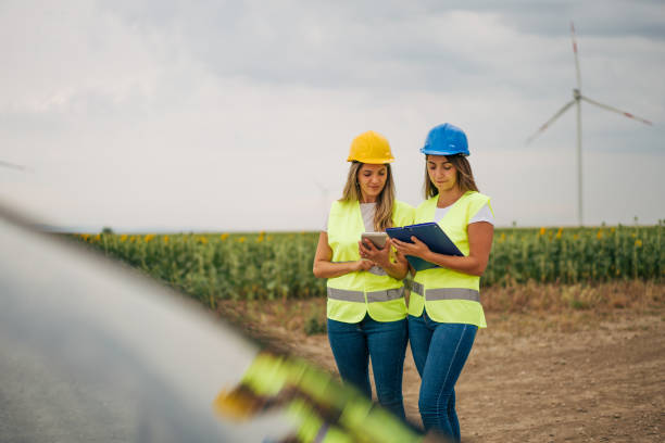 istock two female Engineers , windmill for renewable energy, power and electricity innovation. 2159358881