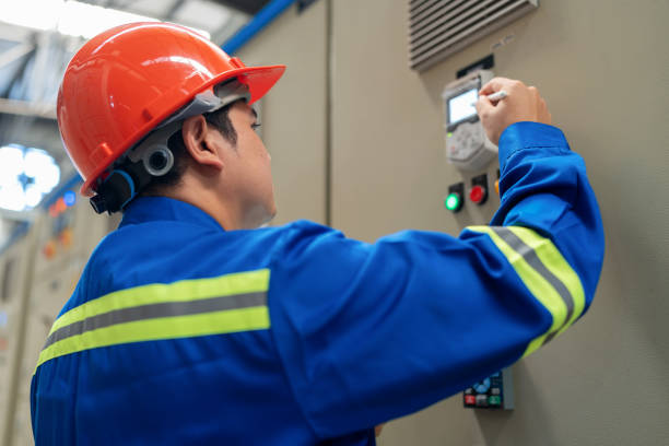 istock Electrical engineers in safety suits and helmets are meticulously inspecting the work systems in an electrical room to prevent system failures. Their expertise and attention to detail ensure the reliability and safety of the electrical infrastructure. 2159362846