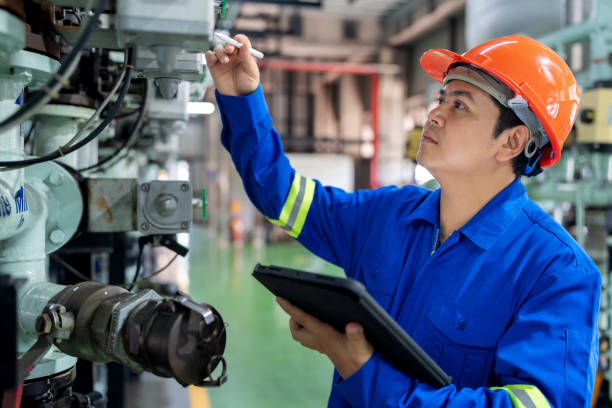 istock A mechanical engineer wearing a hardhat and protective workwear is inspecting pipeline systems and control valves in a lubricant production plant. Utilizing a digital tablet, the engineer ensures the efficiency and accuracy of the industrial equipment. 2159362871