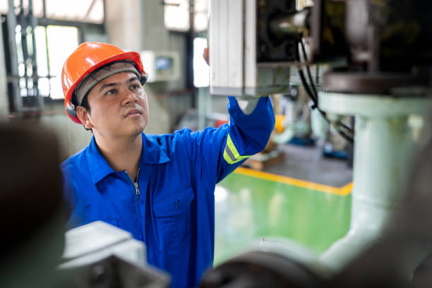 istock An industrial engineer wearing a hardhat and protective workwear examines machinery in a factory setting. The engineer uses a digital tablet to ensure quality control and maintenance of the manufacturing equipment. 2159362872