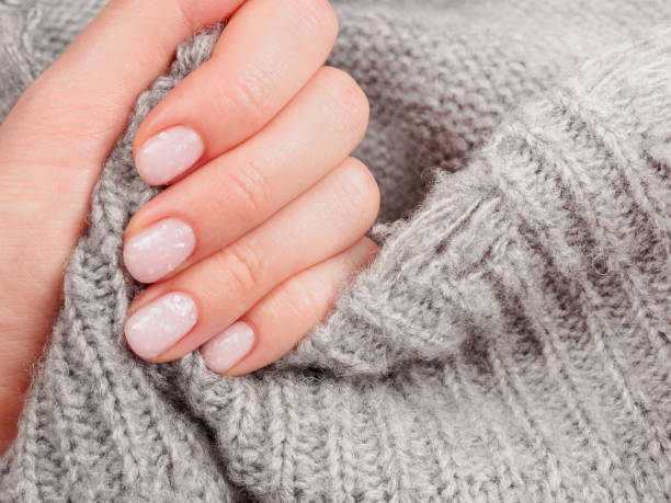 istock Women's manicure shellac soft pink color close-up 2159363047