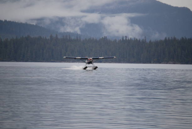 istock Float Plane Landing on Serene Alaskan Lake Amidst Majestic Wilderness 2159363770