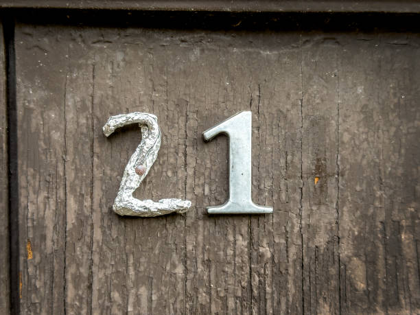 istock Building number on house wooden front door 2159365612