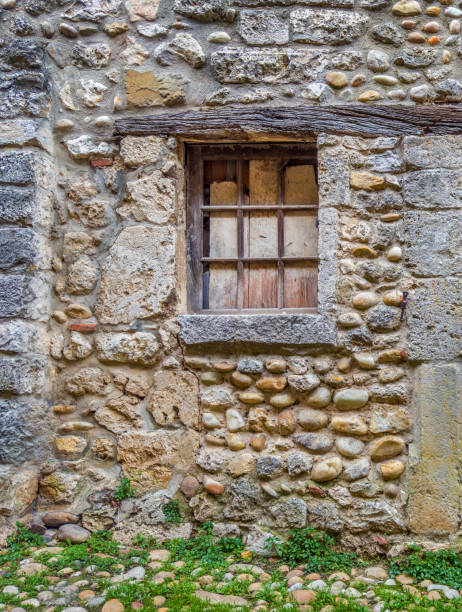 istock Old stone house exterior window with iron security bar 2159365687