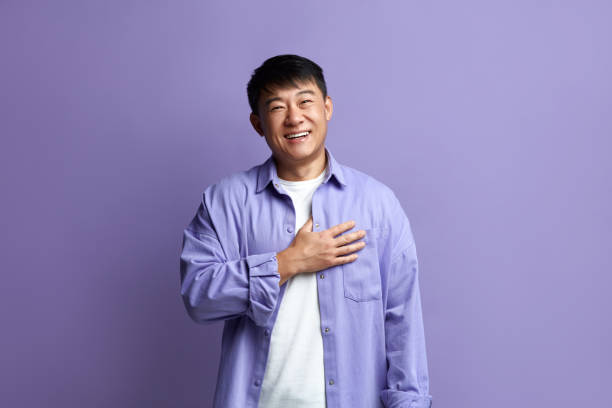 Happy Man Smiling Camera. Cheerful Guy Smiling Sincerely, Holding Hand at Chest