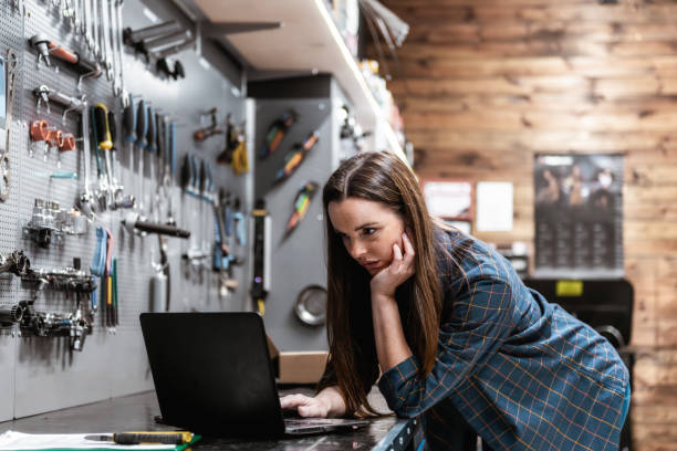 istock young woman looking at laptop in workshop 2159369361