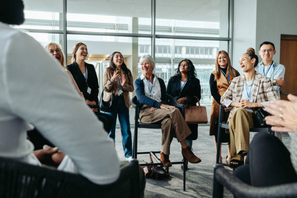 istock Diverse group of colleagues laughing during an office meeting in a modern workspace 2159374376