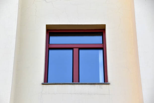 istock A red window on a yellow wall. A beautiful window in a classic building. 2159374934