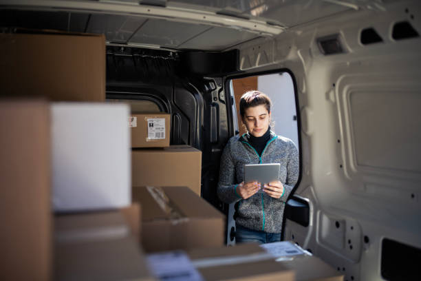 istock Woman delivering packages and using a digital tablet. 2159376019