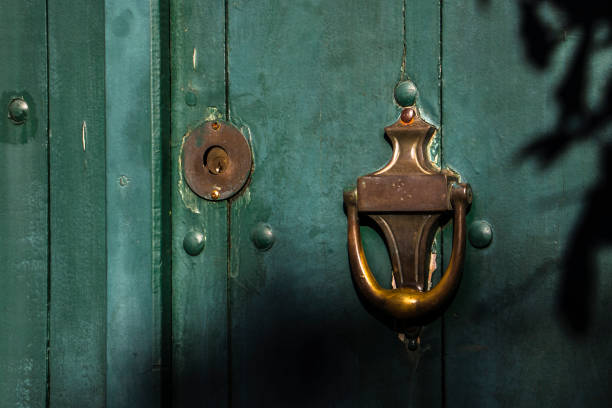 Old wooden doors with an old metal door handle knocker in Brazil