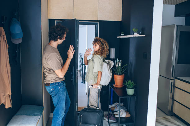 istock Young couple standing in the hallway saying goodbye and leaving 2159378978