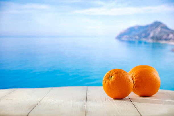 Yellow apple in the sun with the sea in background