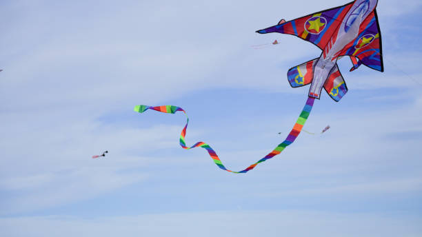 istock Rocket shaped kite flying high in the blue sky 2159379593