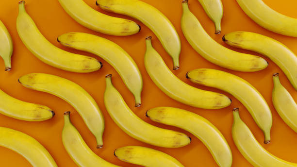istock Bunch of ripe bananas fruit isolated on a orange background. 2159379735