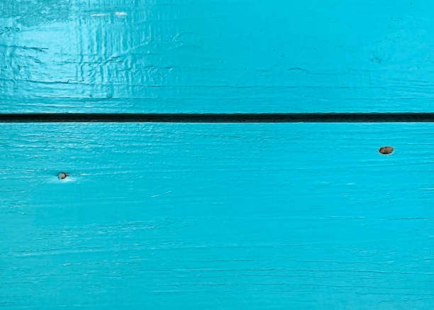 the surface of the old board covered with turquoise paint