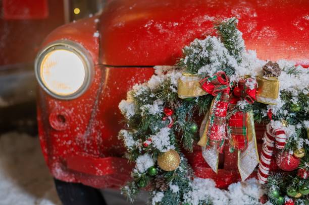 istock Christmas decorations on a red classic car outdoors. Santa claus car 2159385663