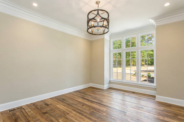 istock Empty Dining Room with Wooden Floor, Large Windows, and A Modern Chandelier 2159385904