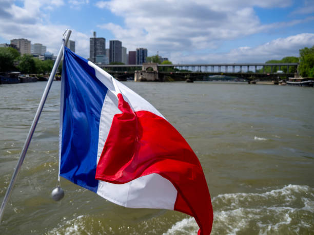 istock French Flag Waving on a Boat in the Seine 2159387630