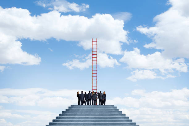 istock Business People Looking Up At Tall Ladder 2159387860