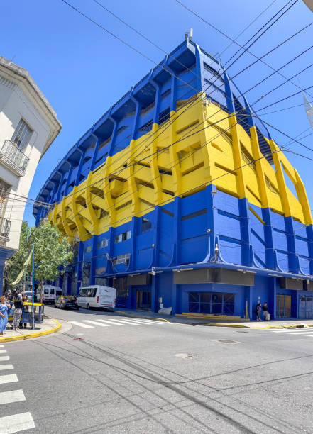 Street view of Boca Juniors stadium on corner in Buenos Aires. People are pictured on the sidewalks.