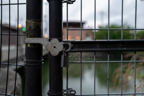 Fence and padlocked door along the river