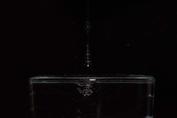 3d render. Close-up of a blue water droplet captured in mid-air as it splashes, surrounded by concentric ripples, emphasizing purity, freshness, and the beauty of natural elements.