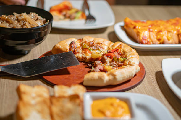istock Table with assorted Italian dishes including pizza and pasta 2159398223