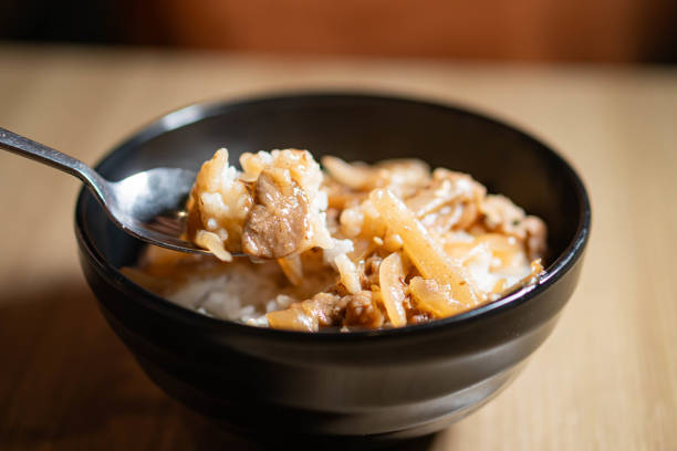 istock Bowl of rice with meat and vegetables 2159398544