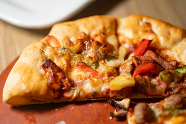 istock Slice of pizza with assorted toppings 2159398666