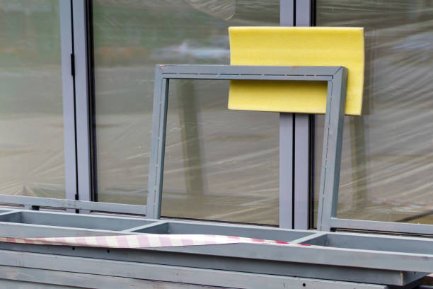 istock Foam padding placed under a metal object to prevent damage to a glass wall, emphasizing protection, safety, and careful handling in delicate installations 2159399715