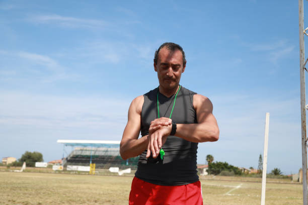 istock Hand Of A Coach Holding A Stopwatch 2159402705