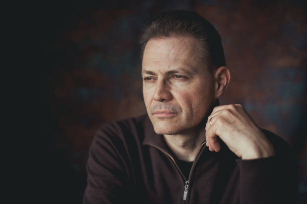 Close up portrait of man, on black background