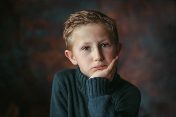 Portrait of unhappy boy with tears in his eyes