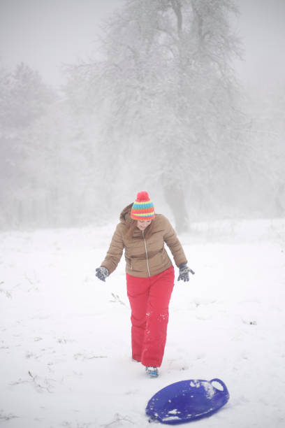 istock Woman riding snow sledge 2159407559